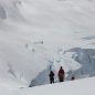 People hiking in the snowy mountains and hills of Antarctica