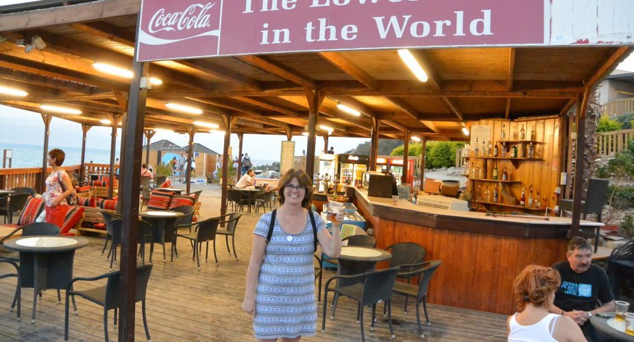 Wendy holding a beer at The Lowest Bar in the World at the Dead Sea