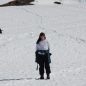 Wendy posing on the snow with a penguin in the background
