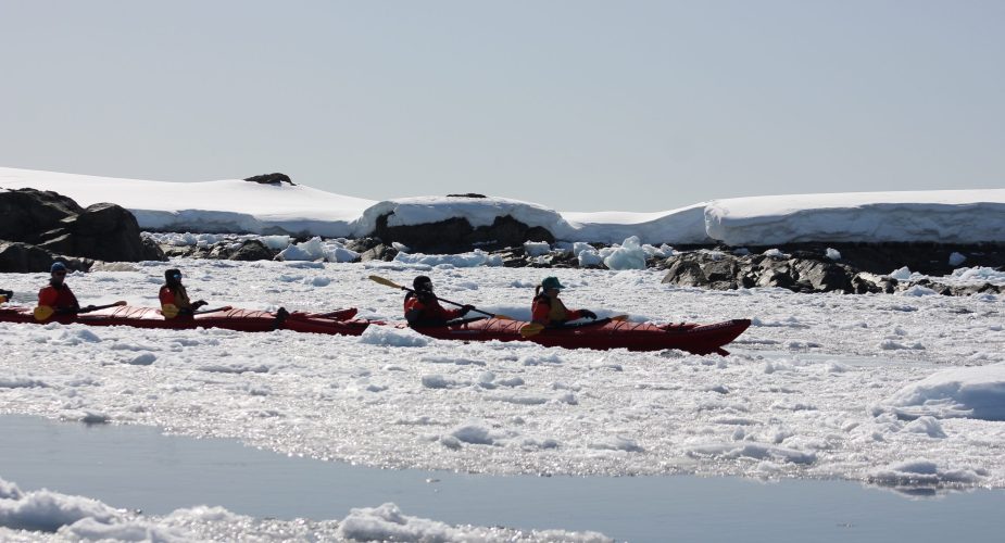 People kayaking through the icy waters in Antarctica