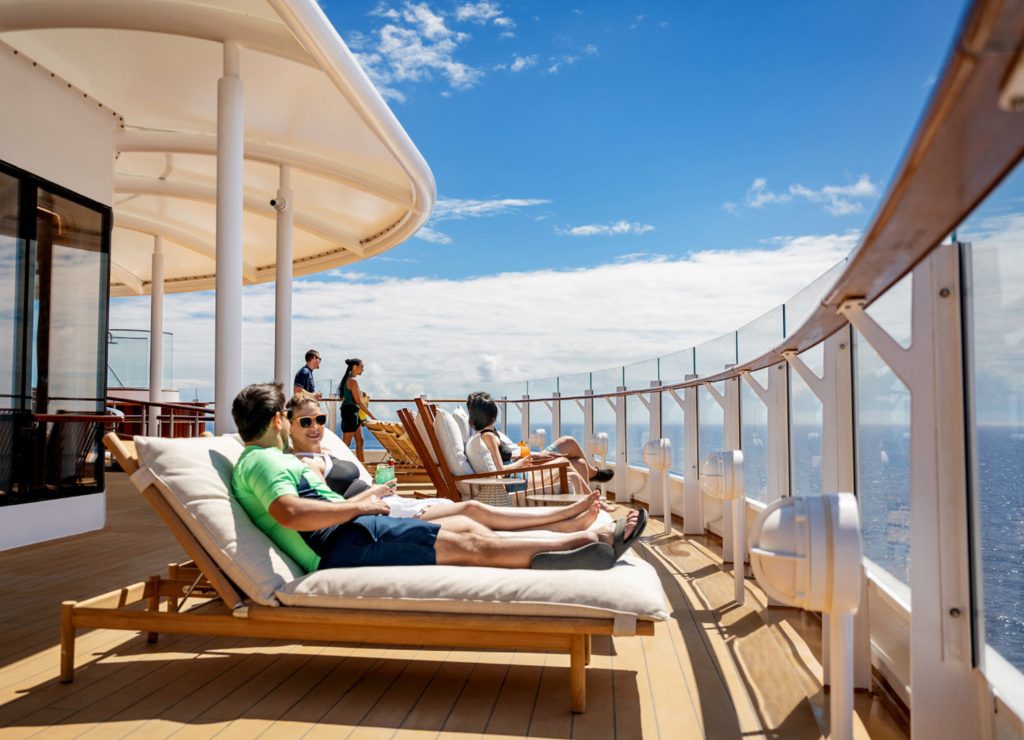 disney cruise top deck with adults enjoying sunbathing and relaxing