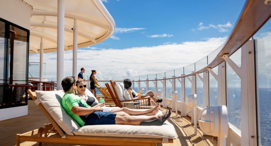 disney cruise top deck with adults enjoying sunbathing and relaxing